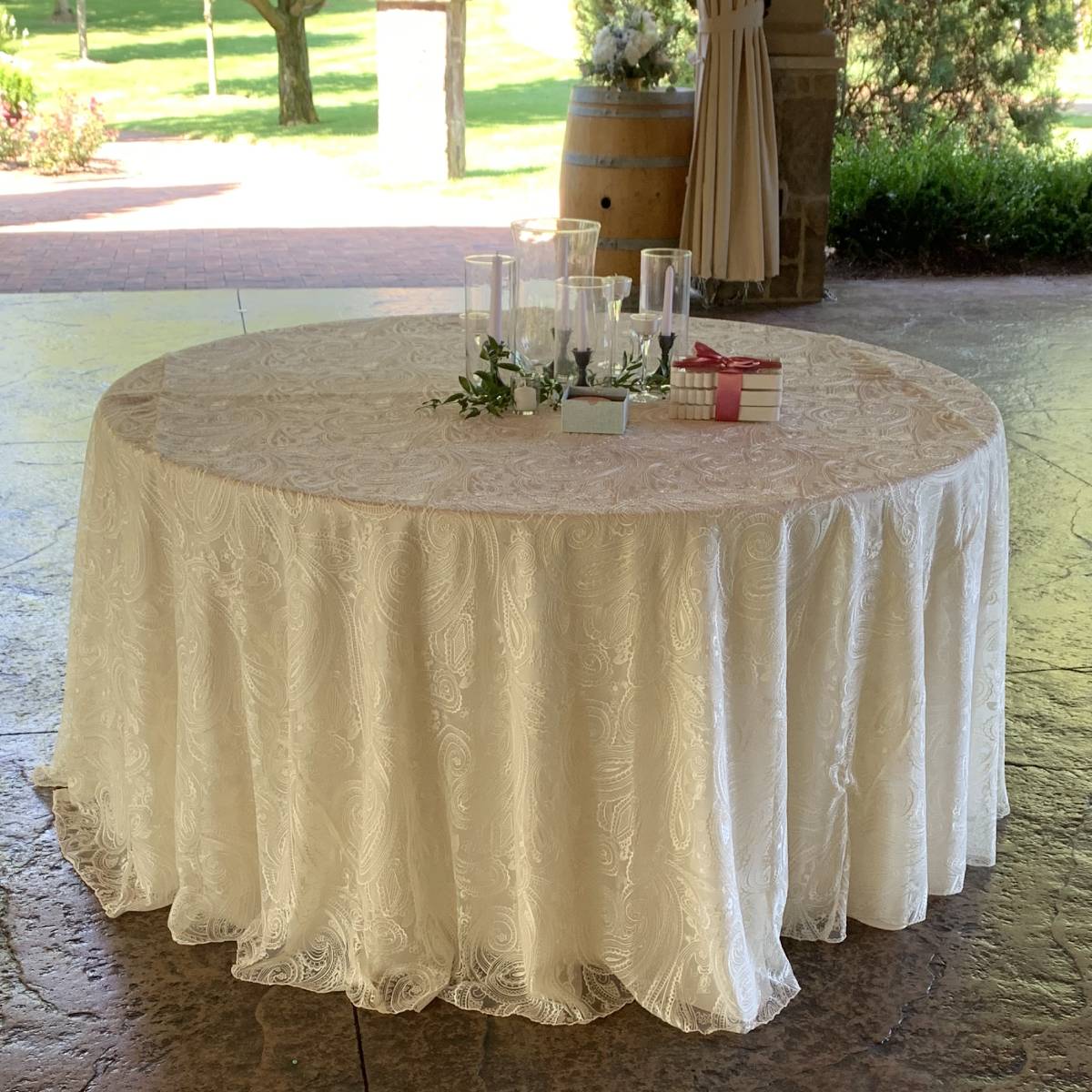 108" Round Ivory Paisley Lace On 108" Round Ivory Solid Tablecover On 48" Round Wood Topped Table